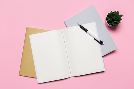 school notebook on a pink background, notepad on a table.Top viewの写真素材