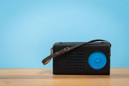 Vintage old radio on wooden table with color wall backgroundの写真素材