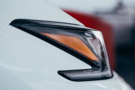 Closeup of car tail light on a white carの写真素材