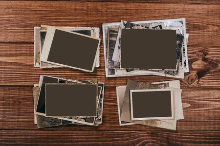 Stack old photos on table. Mock-up blank paper. Postcard rumpled and dirty vintage. Retro cardの写真素材