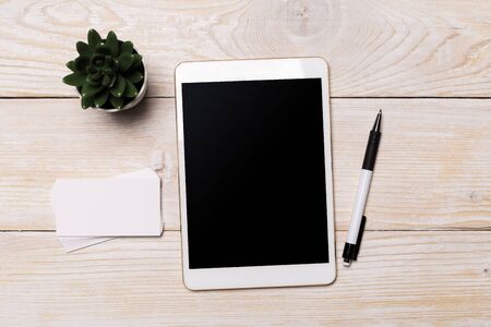 White digital tablet on wooden table. Flat lay.の写真素材