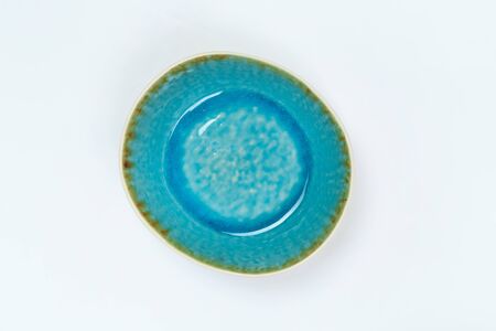 Simple rustic blue handmade dishes on a white backgroundの写真素材