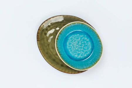 Simple rustic blue handmade dishes on a white backgroundの写真素材