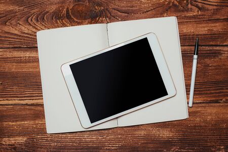 White digital tablet on wooden table. Flat lay.の写真素材