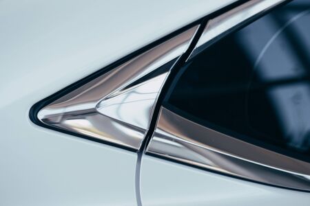 Fragment of steel car body. Vehicle paint coating texture. New car body parts