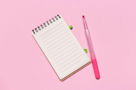 school notebook on a pink background, notepad on a table.Top viewの写真素材