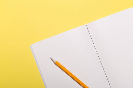 school notebook on a yellow background, notepad on a table.Top viewの写真素材