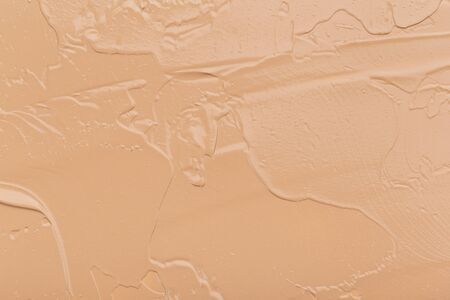 Close up of smear beige and ligth pink tone foundation texture for background.の写真素材