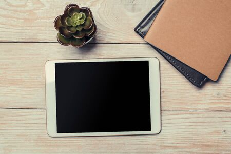 White digital tablet on wooden table. Flat lay.の写真素材