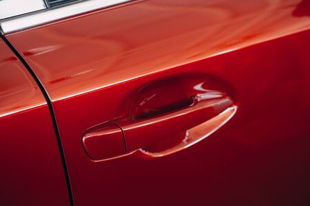 Closeup of red car door handle