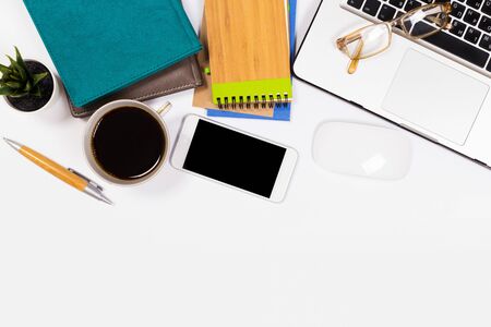 Modern workspace with coffee cup, smartphone, paper, notebook, tablet and laptop copy space on white color background. Top view. Flat lay style.の写真素材
