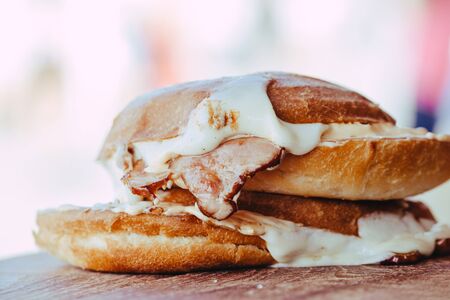 grilled sandwich with ham and cheese on wooden background. street foodの写真素材