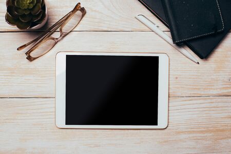 White digital tablet on wooden table. Flat lay.の写真素材