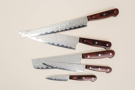 A set of knives lies on a colored background. Professional cook knife.