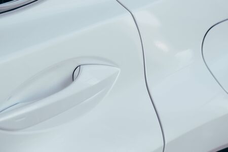 Closeup of white car door handle