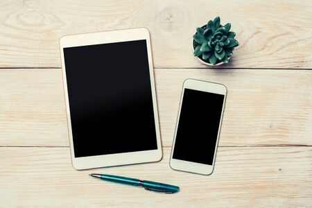 Modern Tablet and smartphone top view on office desk. Top view with copy space.の写真素材