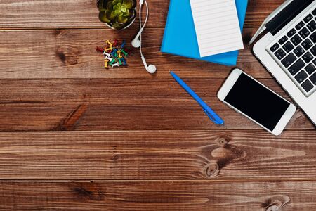 office stuff with notepad, laptop and coffee cup mouse notepad top view shot.の写真素材
