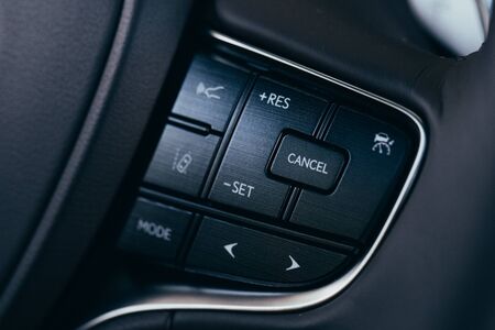 close up Modern black steering wheel with multifunction buttons Integrated stereo controls pushes the for quick control technology in the car.の写真素材