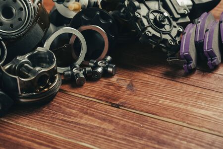 Various car parts on dark woooden background