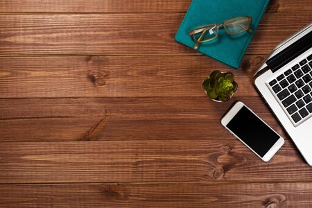 office stuff with notepad, laptop and coffee cup mouse notepad top view shot.の写真素材