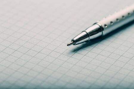 Opened notepad with automatic plastic ballpoint pen close up.の写真素材