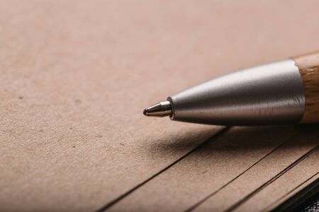 Opened notepad with automatic plastic ballpoint pen close up.の写真素材
