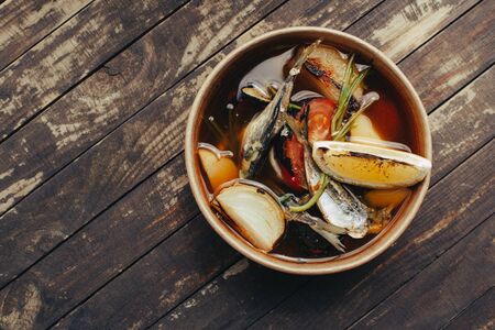 Fresh hot fish soup with ingredients and spices for cooking.