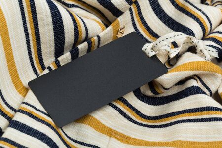 Rectangular Tag on a clothes. fashion, people and shopping concept - close up price tag of clothing itemの写真素材