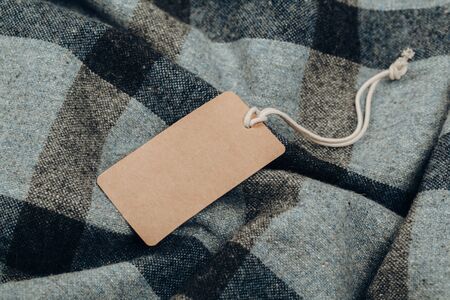 Rectangular Tag on a clothes. fashion, people and shopping concept - close up price tag of clothing itemの写真素材