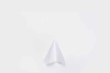 Flat lay of white paper plane and blank paper on white color background.の写真素材