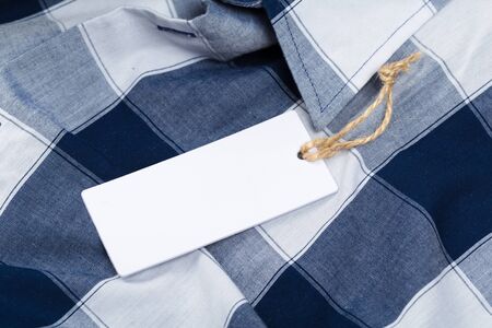 Rectangular Tag on a clothes. fashion, people and shopping concept - close up price tag of clothing itemの写真素材