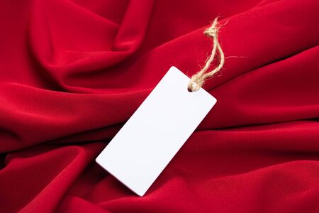 Rectangular Tag on a clothes. fashion, people and shopping concept - close up price tag of clothing itemの写真素材