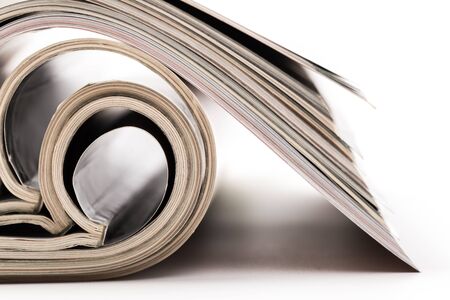 selective focus of the stacking magazine place on white background. Colorful abstract backgroundの写真素材
