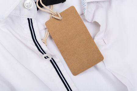 Rectangular Tag on a clothes. fashion, people and shopping concept - close up price tag of clothing itemの写真素材