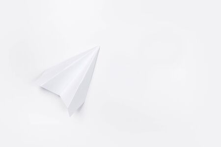 Flat lay of white paper plane and blank paper on white color background.の写真素材