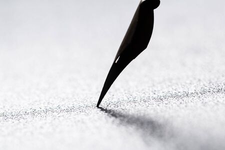 Old fountain pen on a black textured backgroundの写真素材