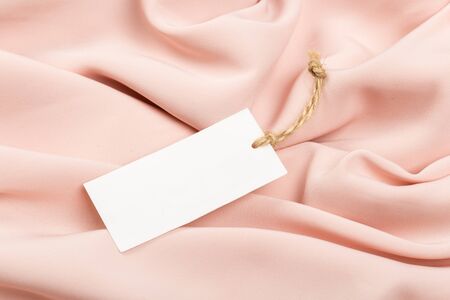 Rectangular Tag on a clothes. fashion, people and shopping concept - close up price tag of clothing itemの写真素材