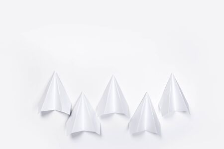 white paper airplane on a white paper background