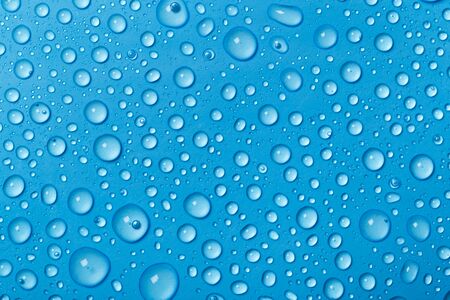 Rain droplets on blue glass background, Water drops on blue glass.の写真素材