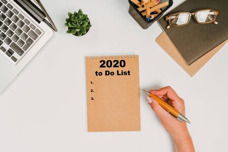 To do list Concept - 2020 number and text on notepad. office stuff with with notepad, laptop and...