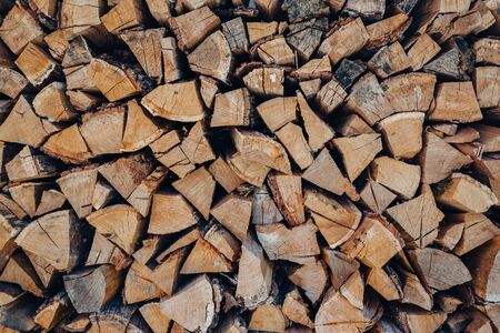 wall firewood, Background of dry chopped firewood logs in a pileの写真素材