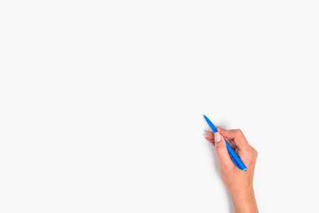 Female hands hold a pen. Isolated on white background. copy space, template.の写真素材