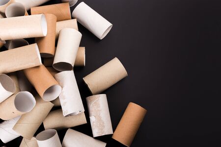 Empty Toilet paper Rolls Stack Up On a Black Backgroundの写真素材