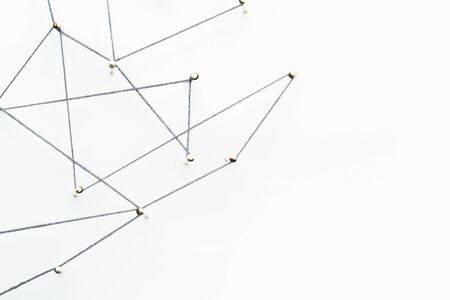 A large grid of pins connected with string. Communication, network conceptの写真素材