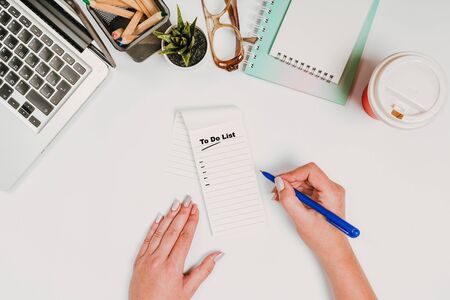 To do list Concept - 2020 number and text on notepad. office stuff with with notepad, laptop and coffee, glasses, notepadの写真素材