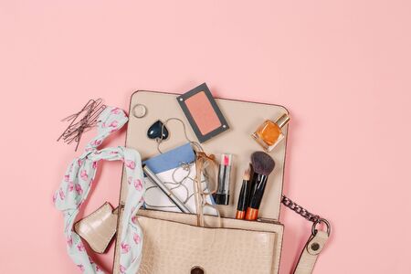 Top view of Women bag and lady stuff with copyspace on pink backgroundの写真素材