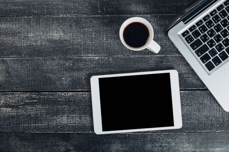 office stuff with notepad, laptop and coffee cup mouse notepad top view shot.の写真素材