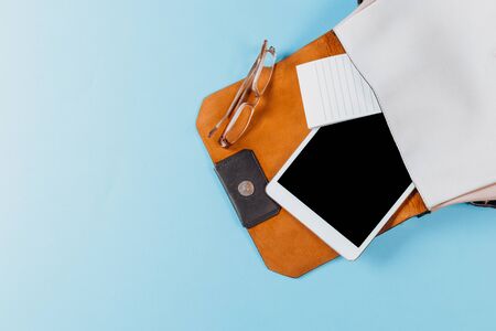 Fashion concept : Flat lay of brown leather woman bag open out with cosmetics, accessories and...