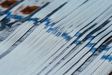 Close up of a lot of american dollar bills on a wooden table