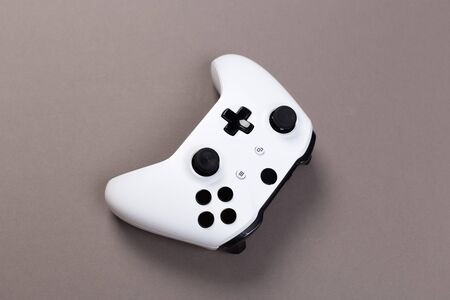 Joystick gaming controller isolated on gray background , Video game console developed Interactive...